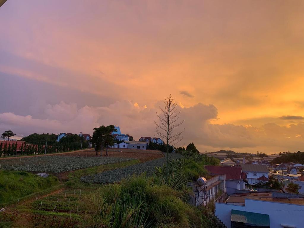 a view of a city with a cloudy sky at sunset at Villa Délight House “Stay&Chill” in Da Lat