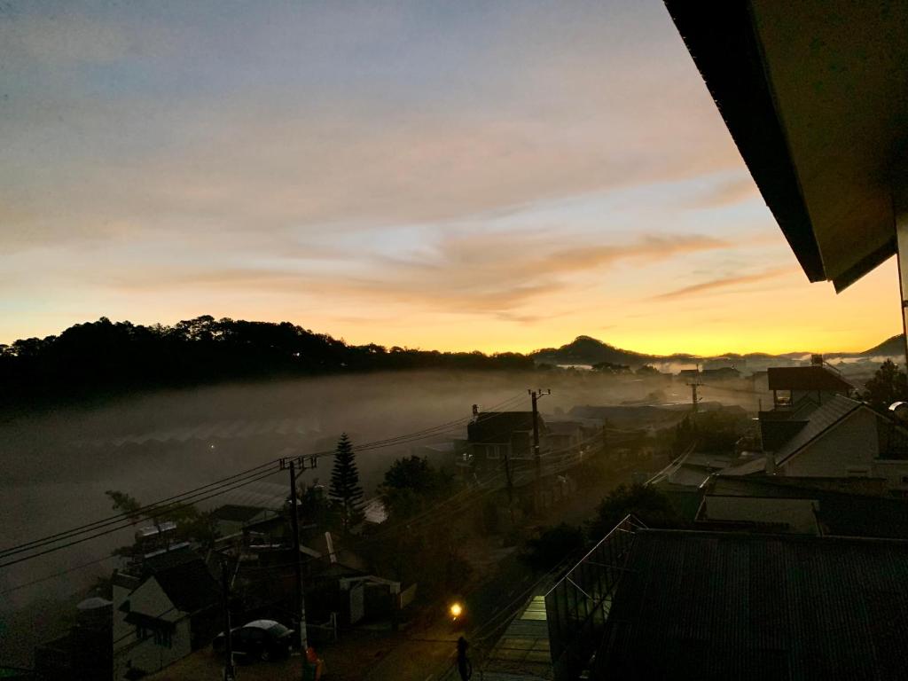 a view of a foggy city at sunset at Villa Délight House “Stay&Chill” in Da Lat
