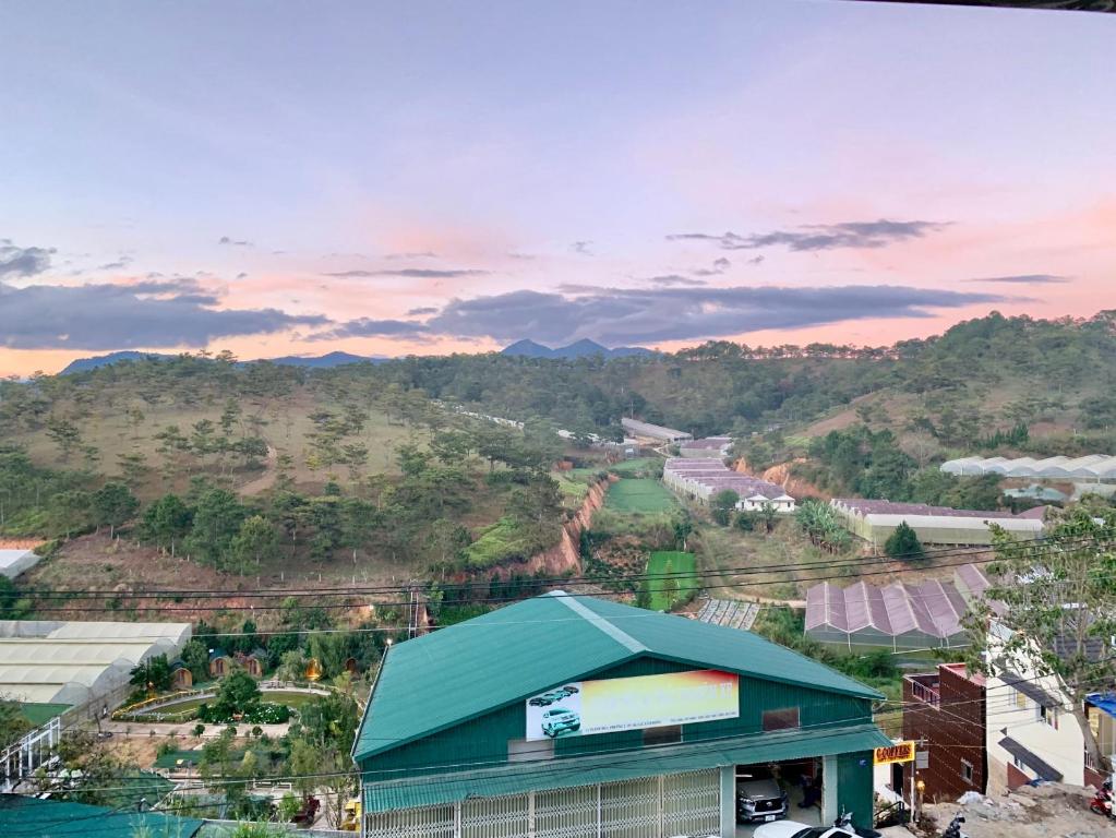 a green building with a view of a mountain at Villa Délight House “Stay&Chill” in Da Lat