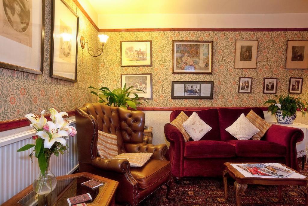 a living room with a couch and a chair at Hodgkinsons Hotel & Restaurant in Matlock