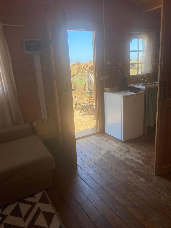 a room with a door open to a kitchen with a table at Cabaña abundancia in El Palmar