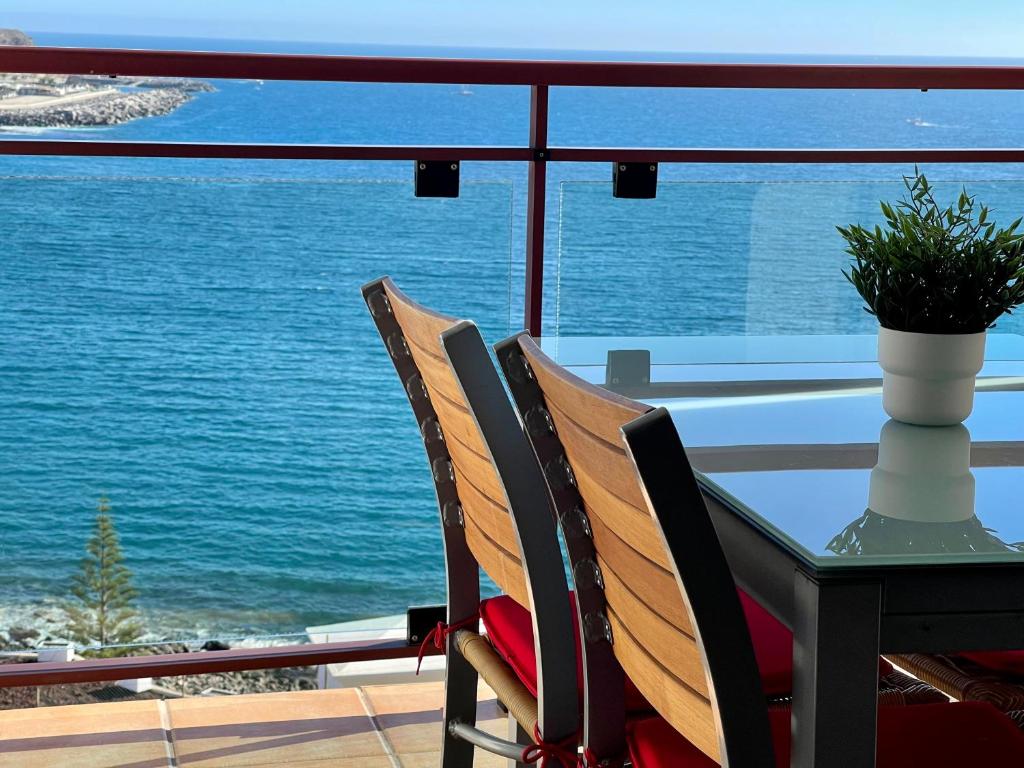 Su Eminencia - Luxury Apartment في بلايا ديل كورا: طاولة وكراسي مطلة على المحيط