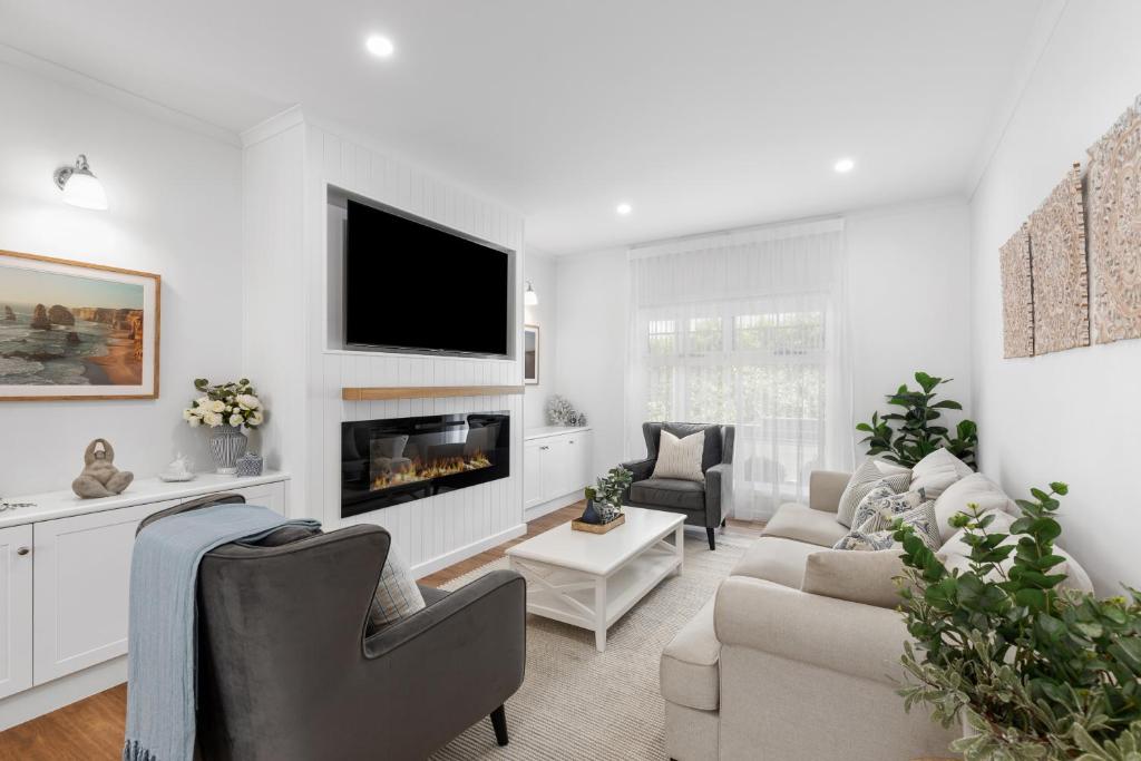 a living room with a couch and a fireplace at Foxmount Estate - MAGNUS in Mount Gambier