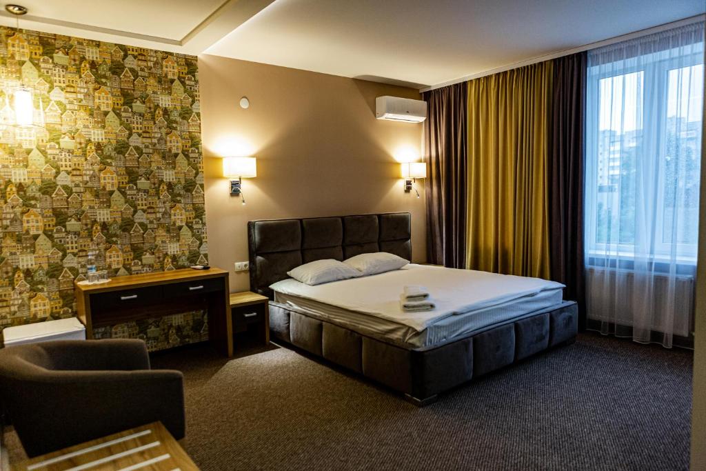 a hotel room with a bed and a chair at Hotel Shengen "Шенген" in Kropyvnytskyi