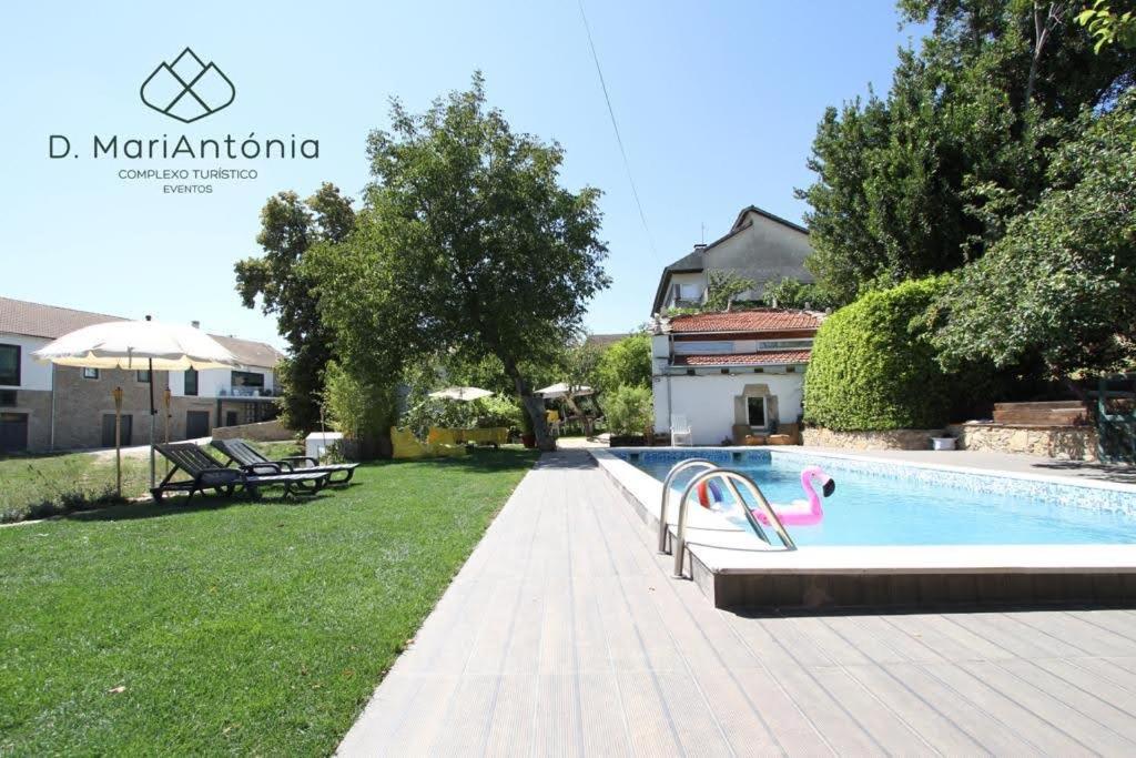 a swimming pool in the backyard of a house at D. MariAntónia Complexo Turístico in Bragança