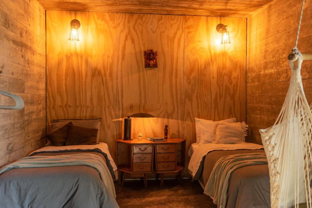 a room with two beds and a table with a lamp at CASA LOBO - La Pedrera -Luxury- Diseño junto al Mar in La Pedrera