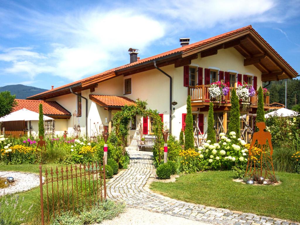 a house with a garden in front of it at Feriendomizil Stöberl - Chiemgau Karte in Inzell