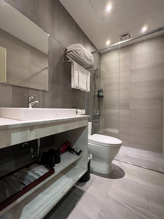 a bathroom with a sink and a toilet at Saint Hostel in Beigang