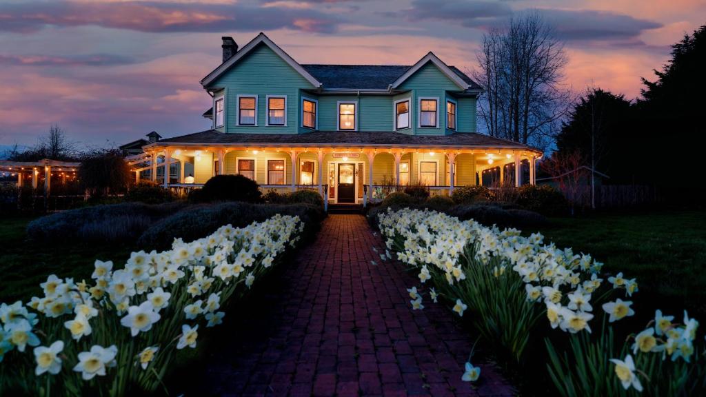 a house with white flowers in front of it at The Edenwild Boutique Inn in Lopez