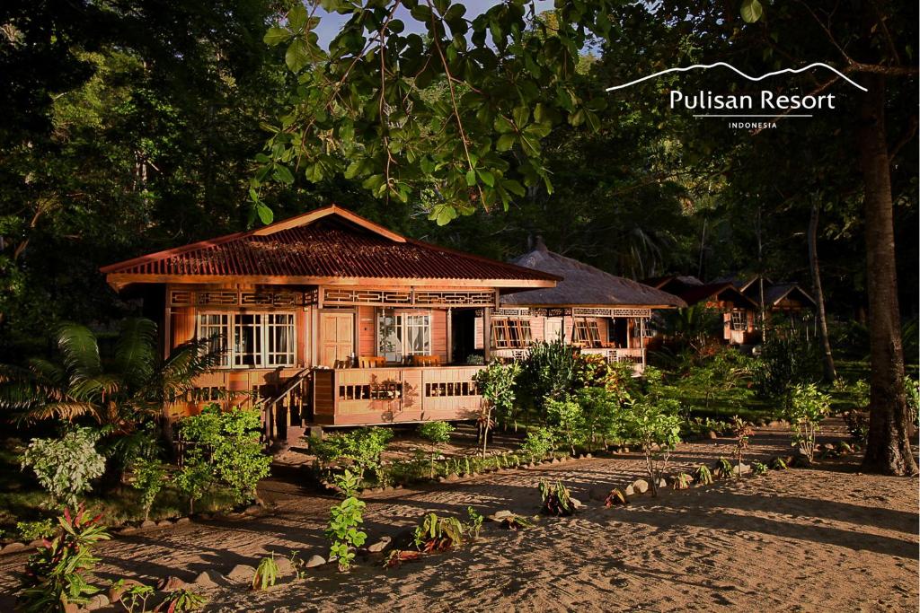 a wooden house in the middle of a forest at Pulisan Resort in Rinondoran