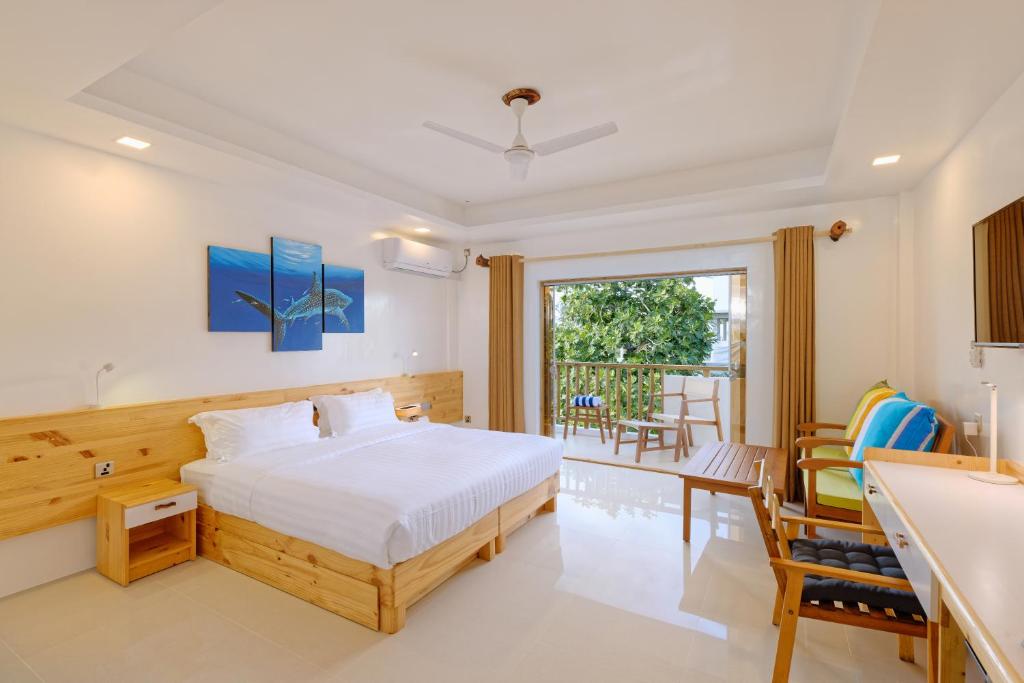 Postel nebo postele na pokoji v ubytování Luau Beach Inn, Maldives