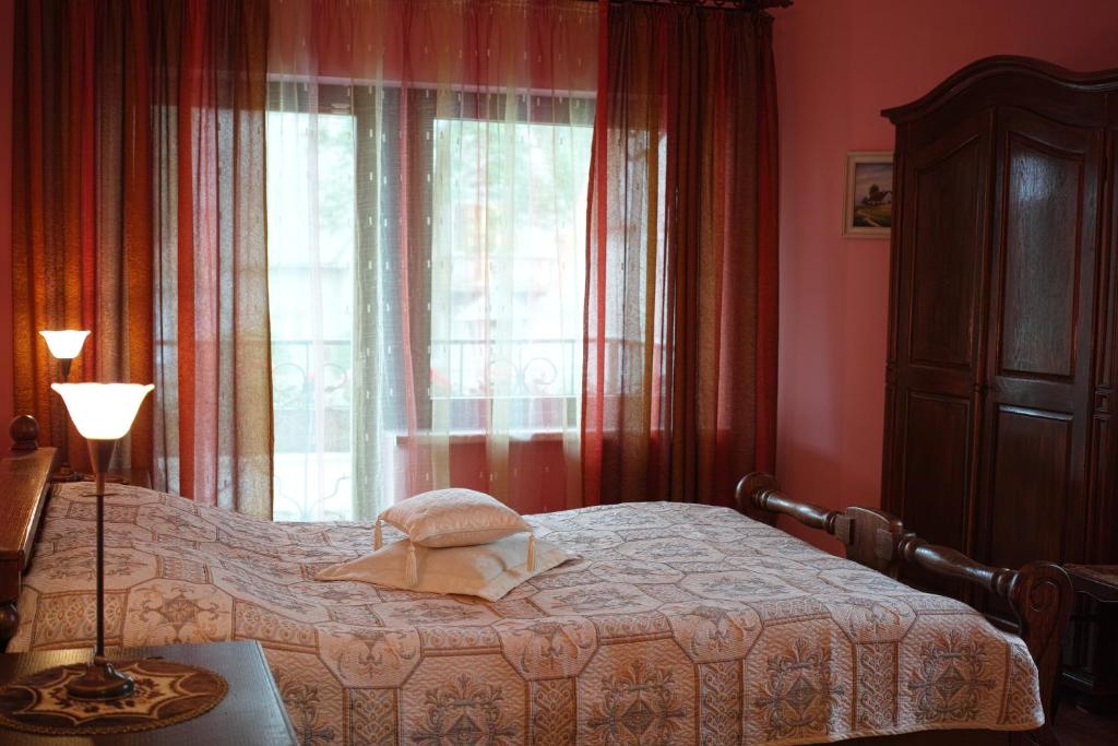 a bedroom with a bed in front of a window at Adomo Rojus in Palanga