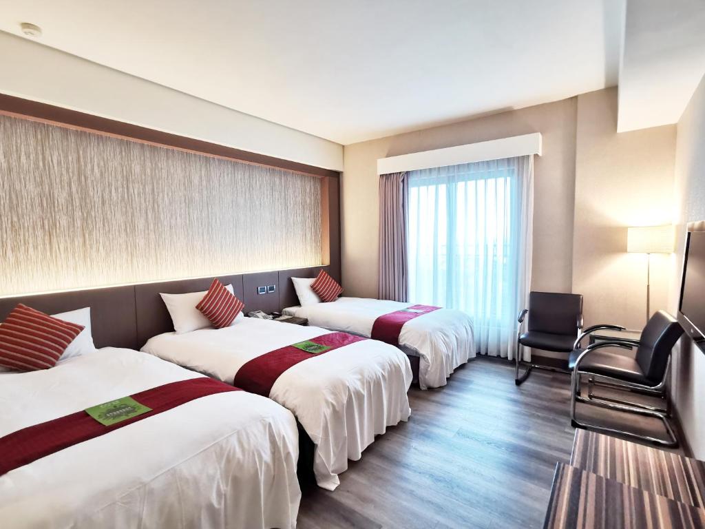 Ліжко або ліжка в номері Lishiuan Hotel