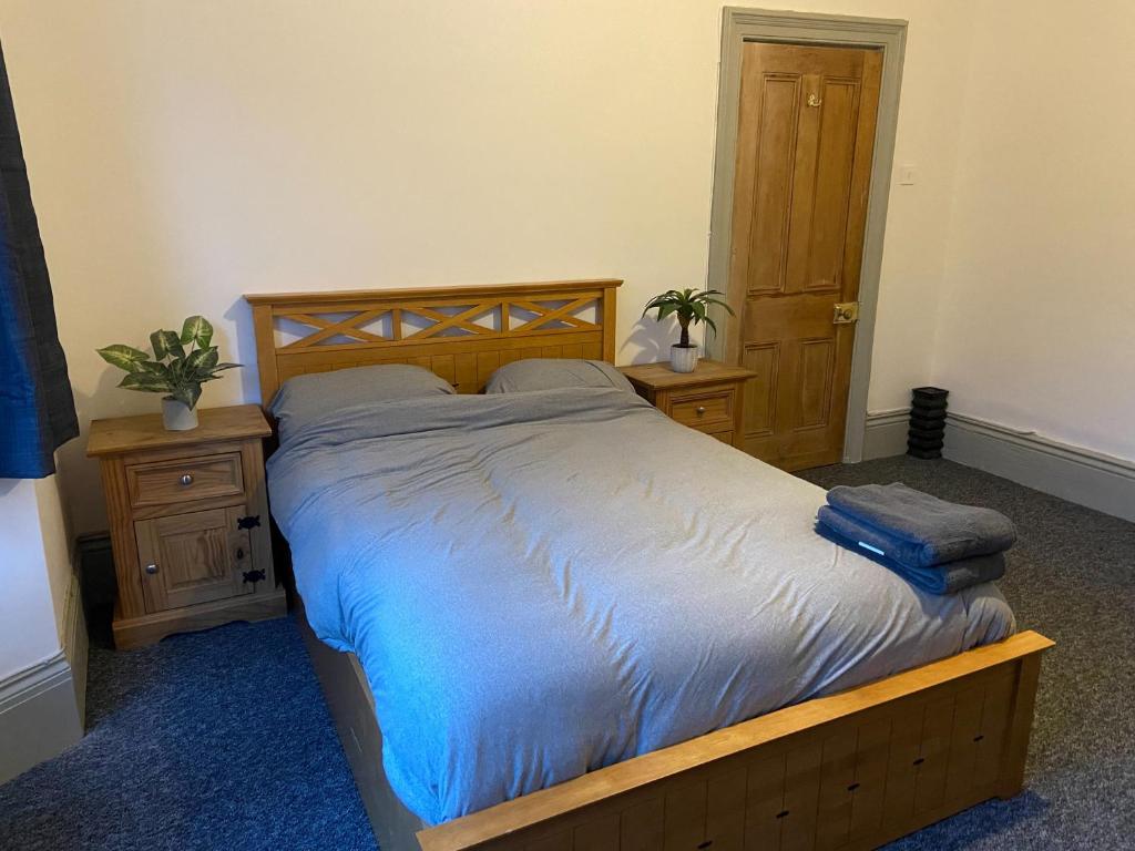 a bedroom with a bed with a blue comforter at Newcastle Apartment 3 - Free Parking in Old Walker