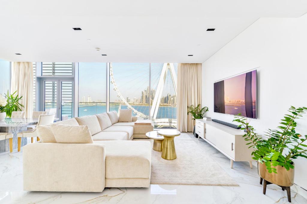a living room with a couch and a tv at Most beautiful 3 BR apt in BLUEWATERS ISLAND, DUBAI in Dubai
