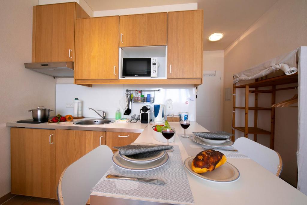 a kitchen with a table with a turkey on it at Apartments Gelsomino, Orchidea and Magnolia in Castagnola