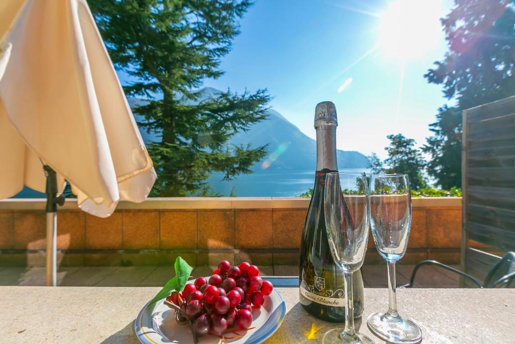 a table with a bottle of champagne and two glasses at Apartments Gelsomino, Orchidea and Magnolia in Castagnola