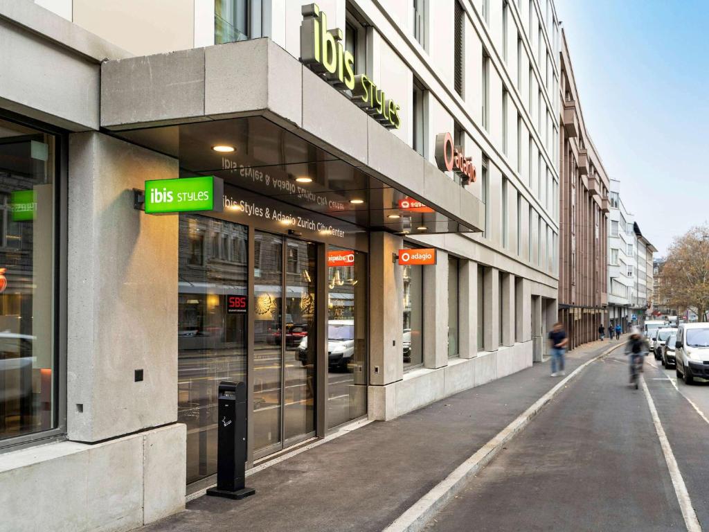 a building on a street with a sign on it at ibis Styles Zurich City Center in Zürich