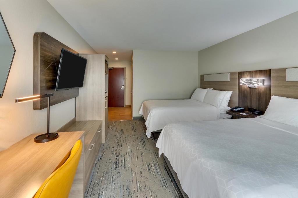 a hotel room with two beds and a flat screen tv at Holiday Inn Express & Suites - Ardmore by IHG in Ardmore