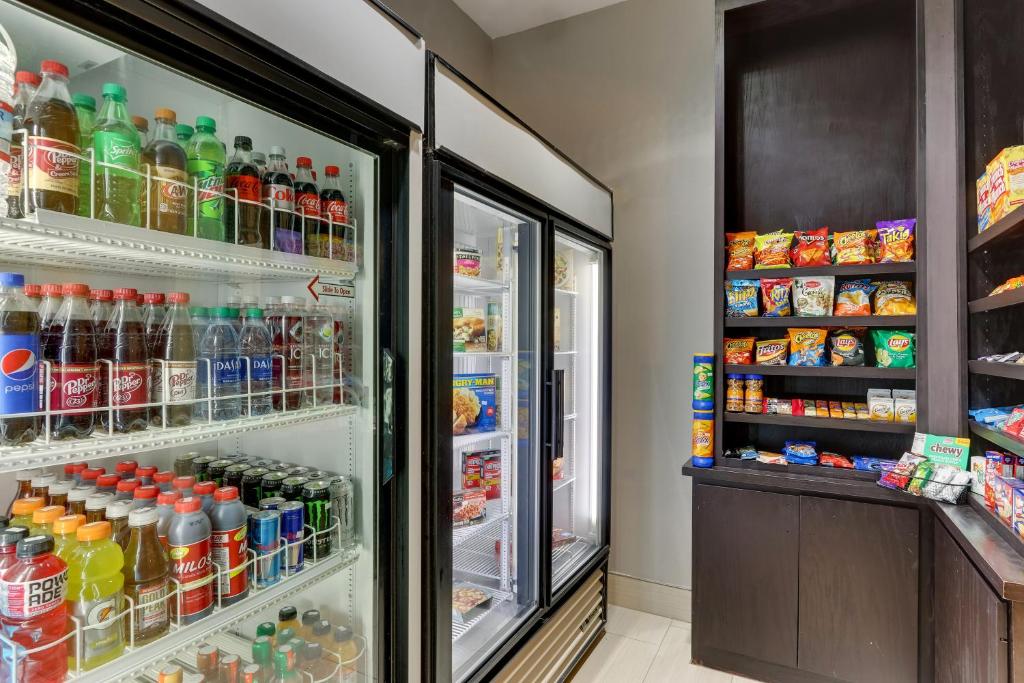 a refrigerator filled with lots of soda and drinks at Holiday Inn Express & Suites - Ardmore by IHG in Ardmore