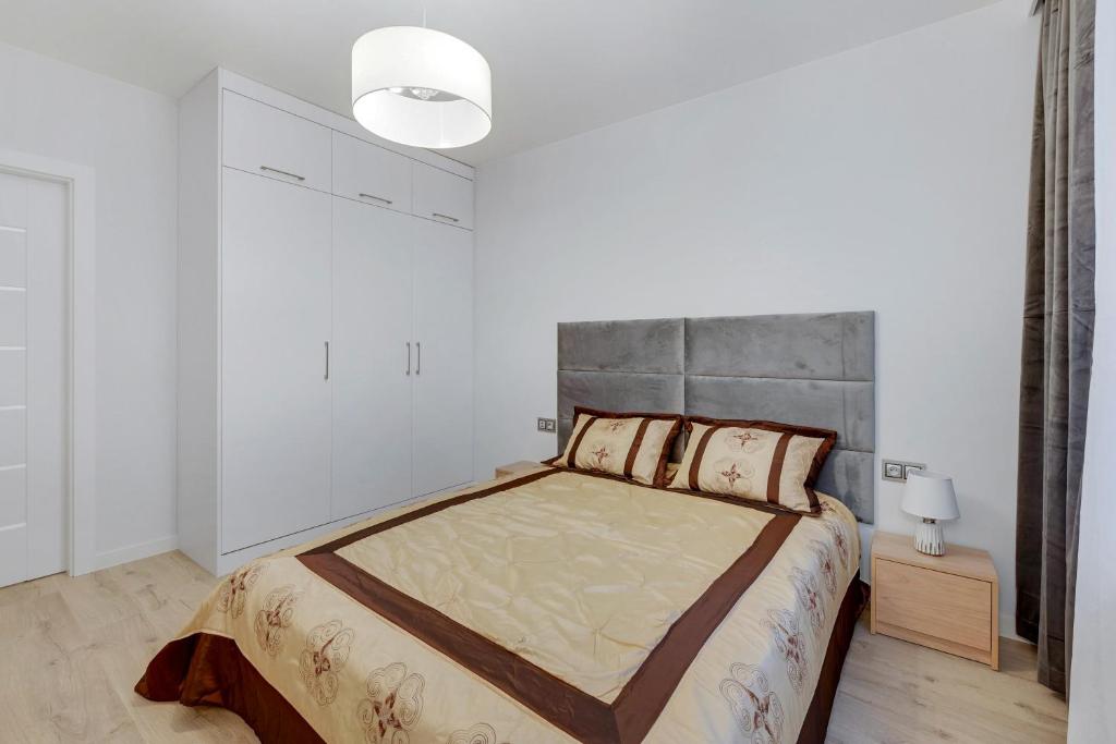 Łóżko lub łóżka w pokoju w obiekcie Comfort Apartments Wilcza