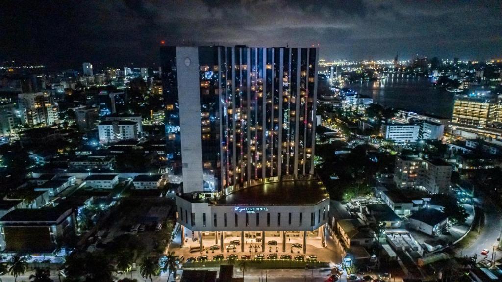 a lit up city at night with a tall building at Lagos Continental Hotel in Lagos