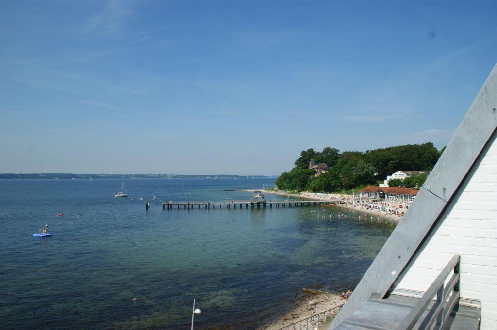 a view of a beach with a pier in the water at Meer-Studio in Glücksburg