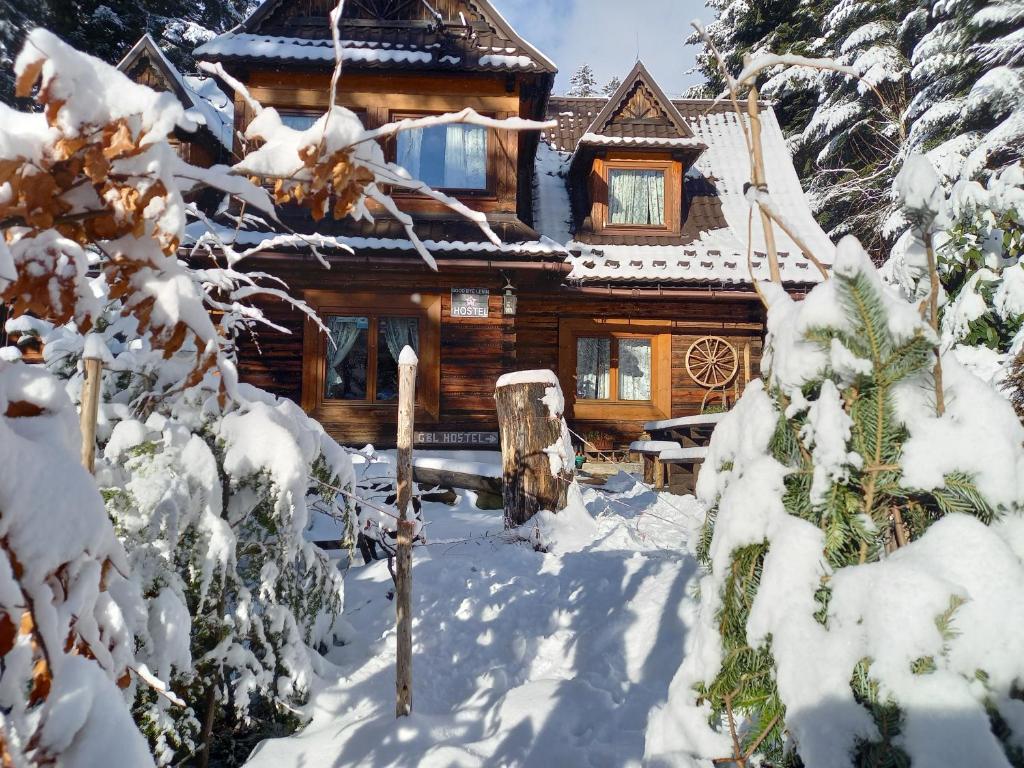 a log cabin in the snow at Good Bye Lenin Hostel Zakopane in Zakopane