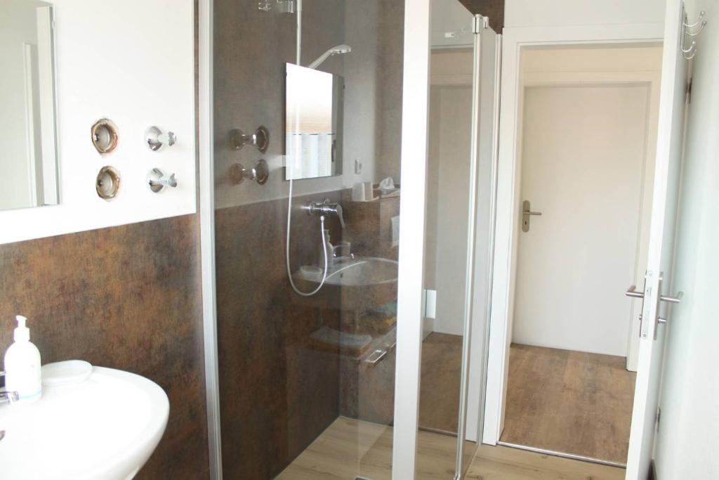 a bathroom with a shower and a sink at Ferienwohnung Niedermoosen in Riedering