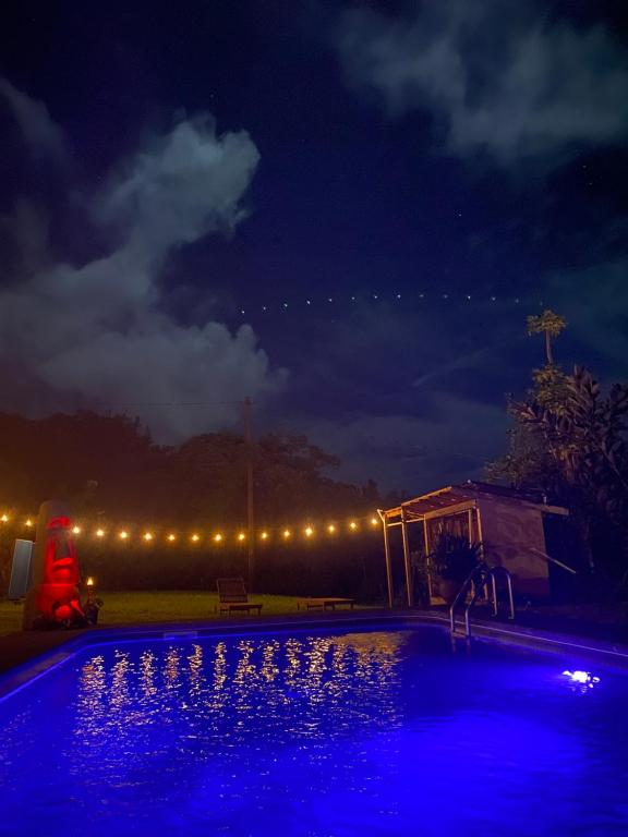 a swimming pool lit up at night with lights at Hawaii Island Resort in Naalehu