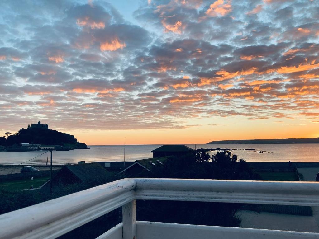 a view of a sunset from a balcony at Sea Breeze in Marazion