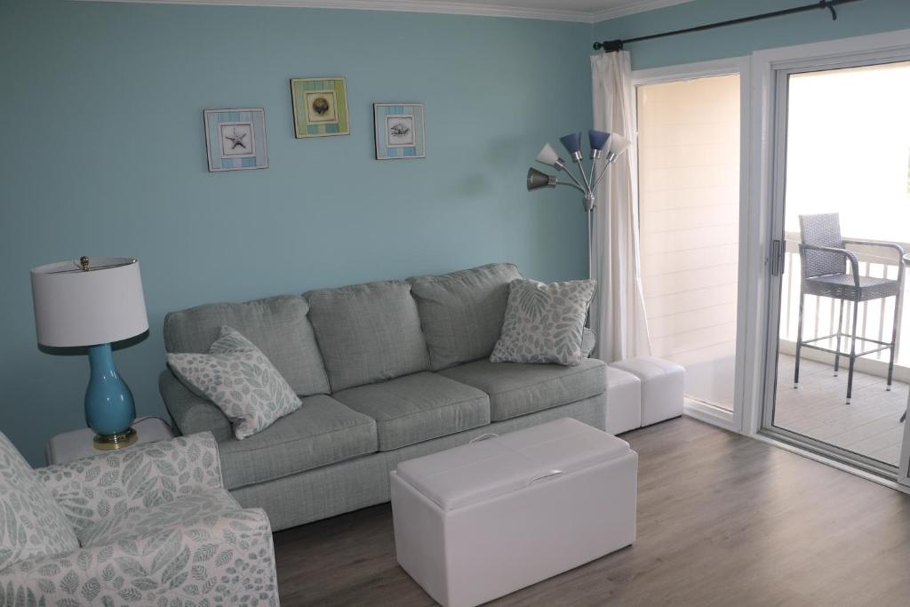 a living room with a couch and a chair at ABPAB89 A Place at the Beach 355 in Atlantic Beach