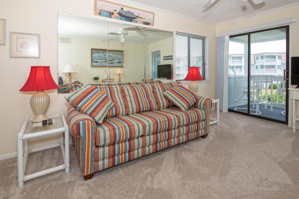 a living room with a couch and a table with lamps at Seaspray II in Atlantic Beach