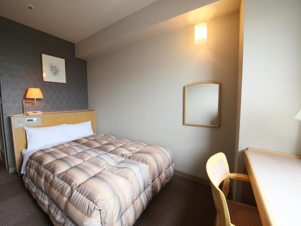 Postel nebo postele na pokoji v ubytování Rako Hananoi Hotel