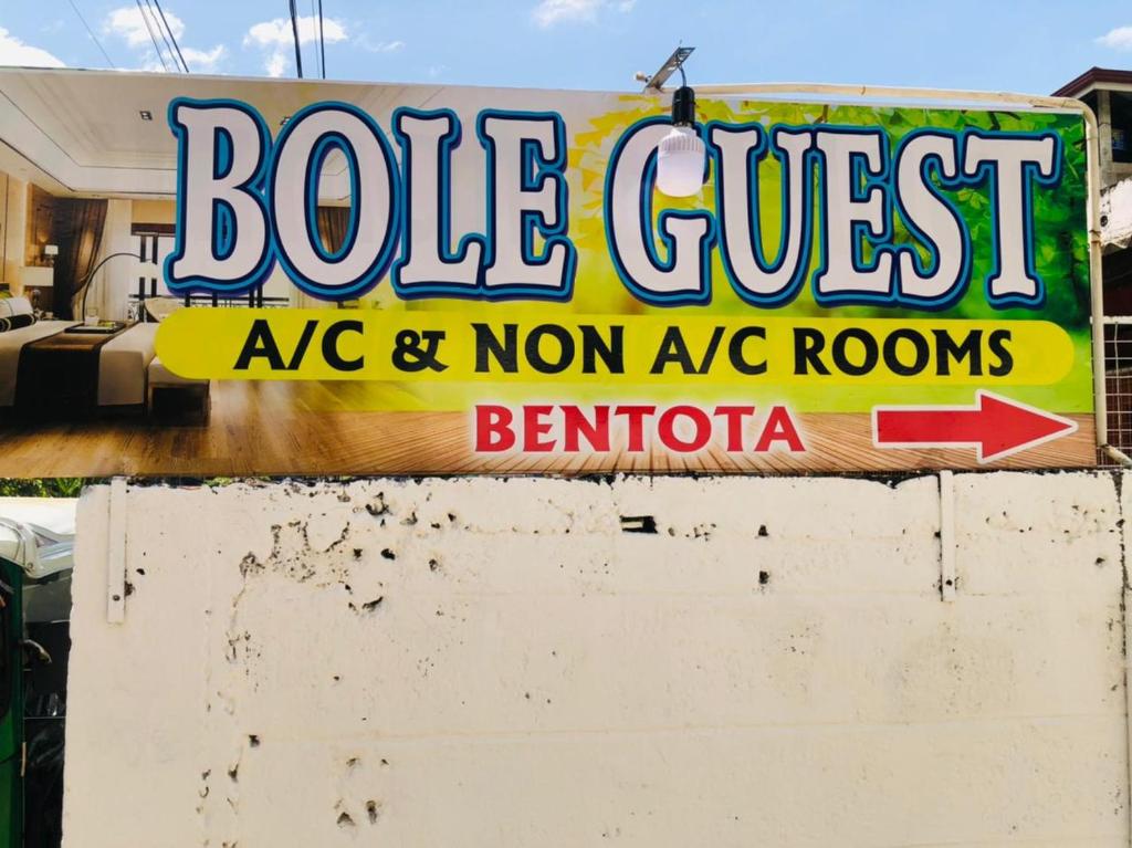 a sign for a pole guest ac cafe and non ac rooms at Bole Guest Bentota in Bentota