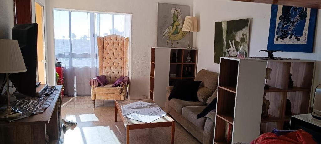 a living room with a couch and a table at Ideal location Very spacious apartment in Maspalomas