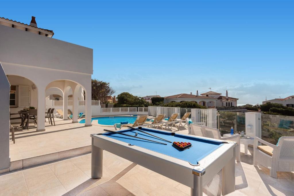 a pool table on the patio of a house at Chalet en Calan Forcat in Cala en Forcat