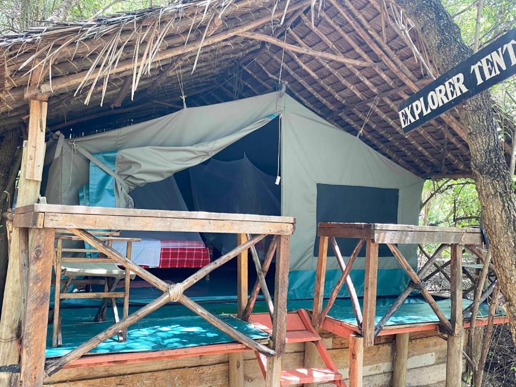 a small tent with a bed in front of it at Maasai Simba Camp in Amboseli