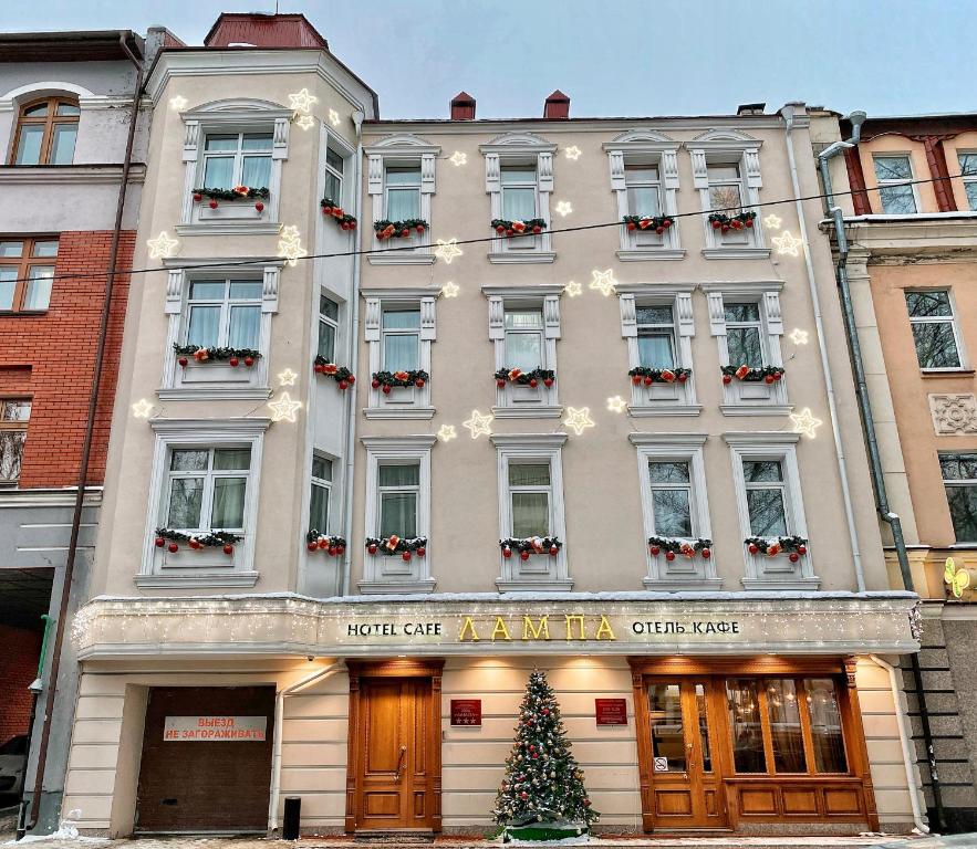 a building with a christmas tree in front of it at Hotel Lampa in Kazan