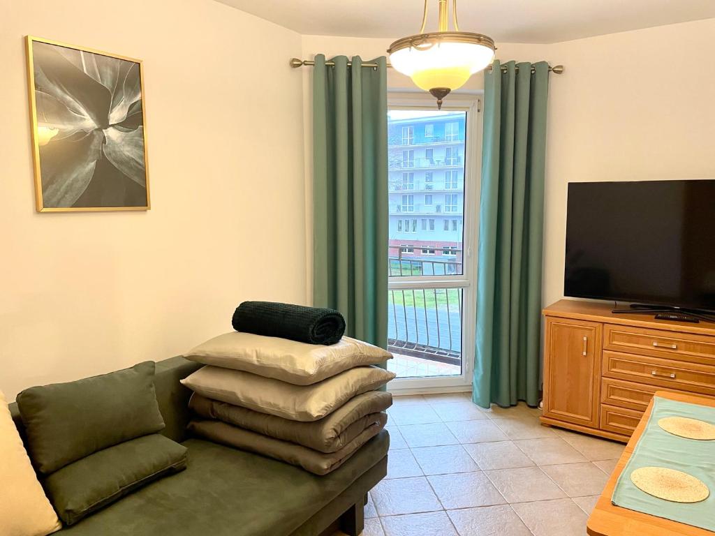 Televízia a/alebo spoločenská miestnosť v ubytovaní Apartament relax 2