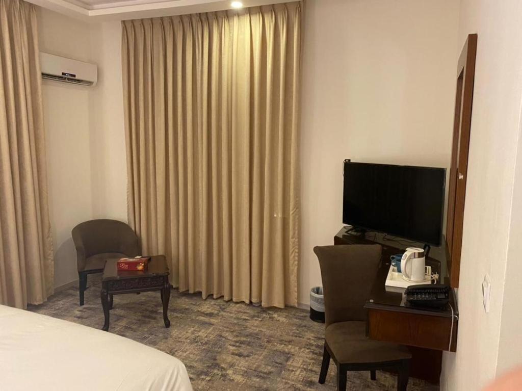 a hotel room with a bed and a television at Jordan View Hotel in Amman