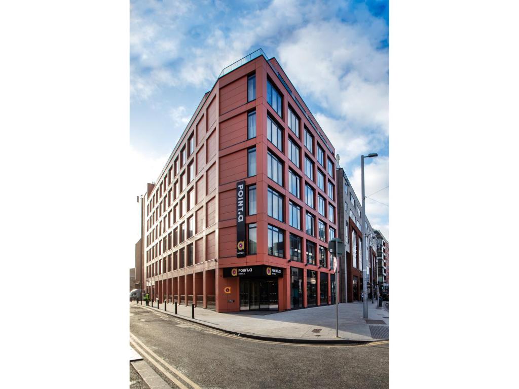 a red building on the corner of a street at Point A Hotel Dublin Parnell Street in Dublin