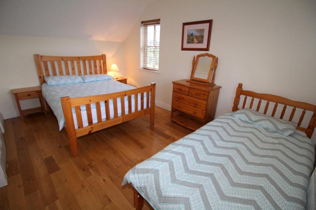 Postel nebo postele na pokoji v ubytování SeaSpray Cottage