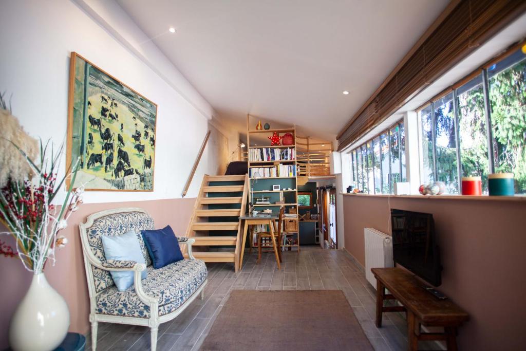 a living room with a chair and a table at LYONEST chambre d'hôtes in Lyon