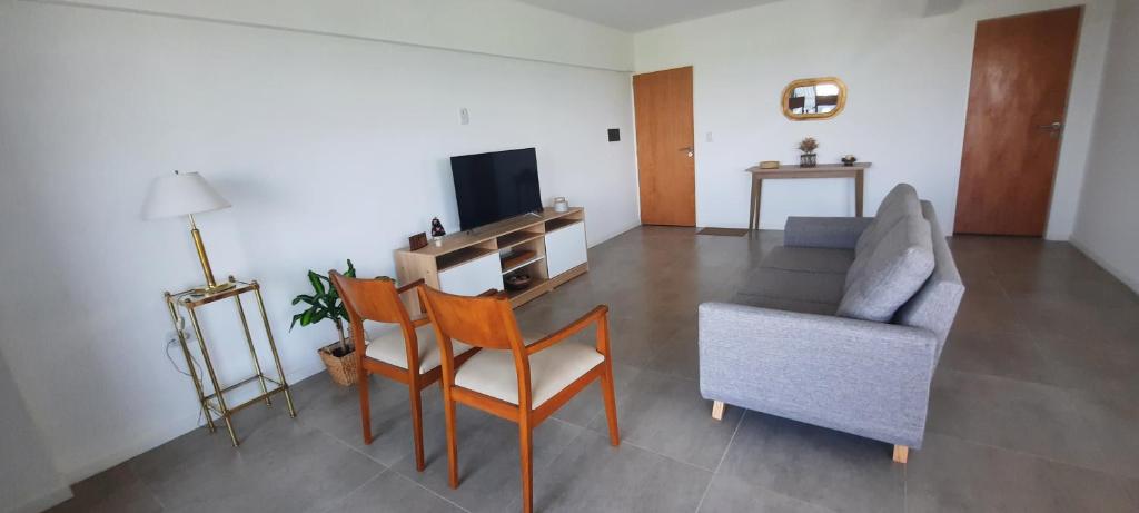 a living room with a couch and a chair at Departamento con vista al río in Victoria