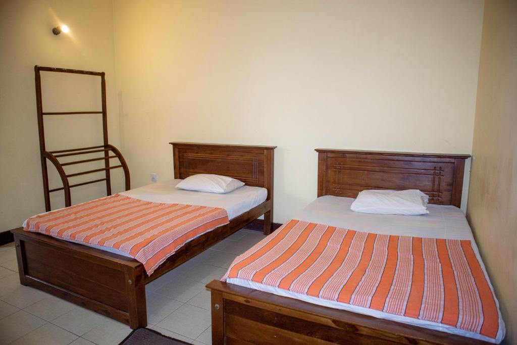 Postel nebo postele na pokoji v ubytování Chamaya Holiday Inn