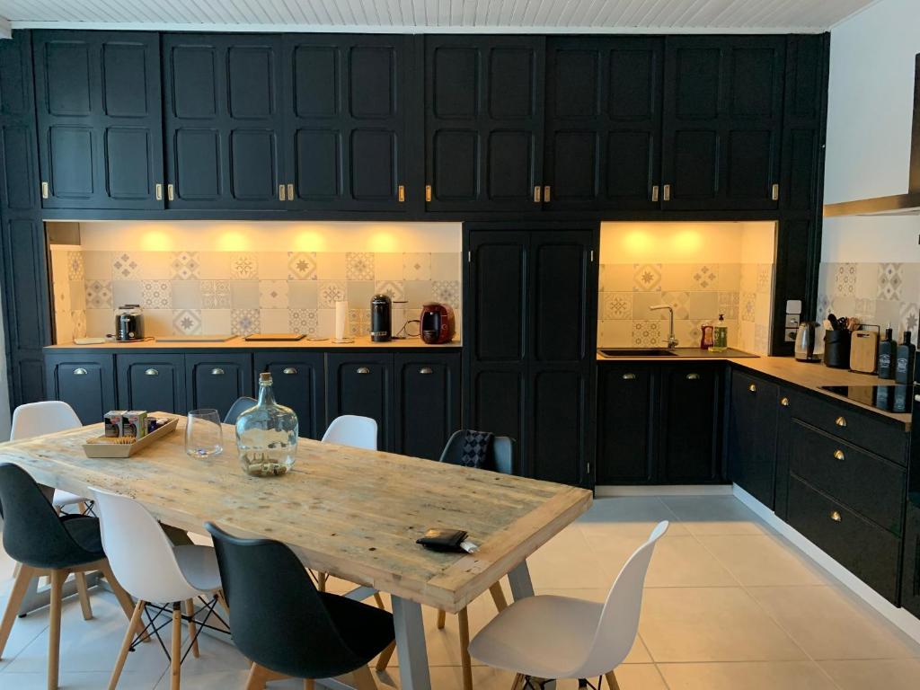 une cuisine avec une table et des chaises en bois dans l'établissement Au bon coin, à Sarlat-la-Canéda