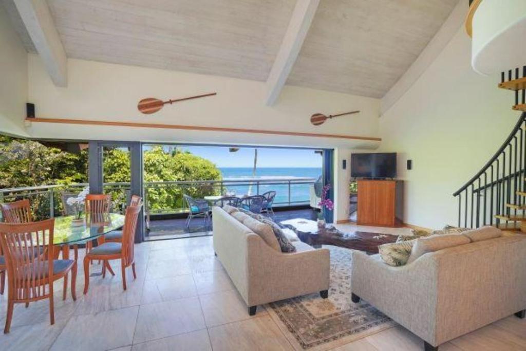 a living room with a view of the ocean at Luxury 2-Story Oceanfront Condo w/ Views & Pool in Wailua