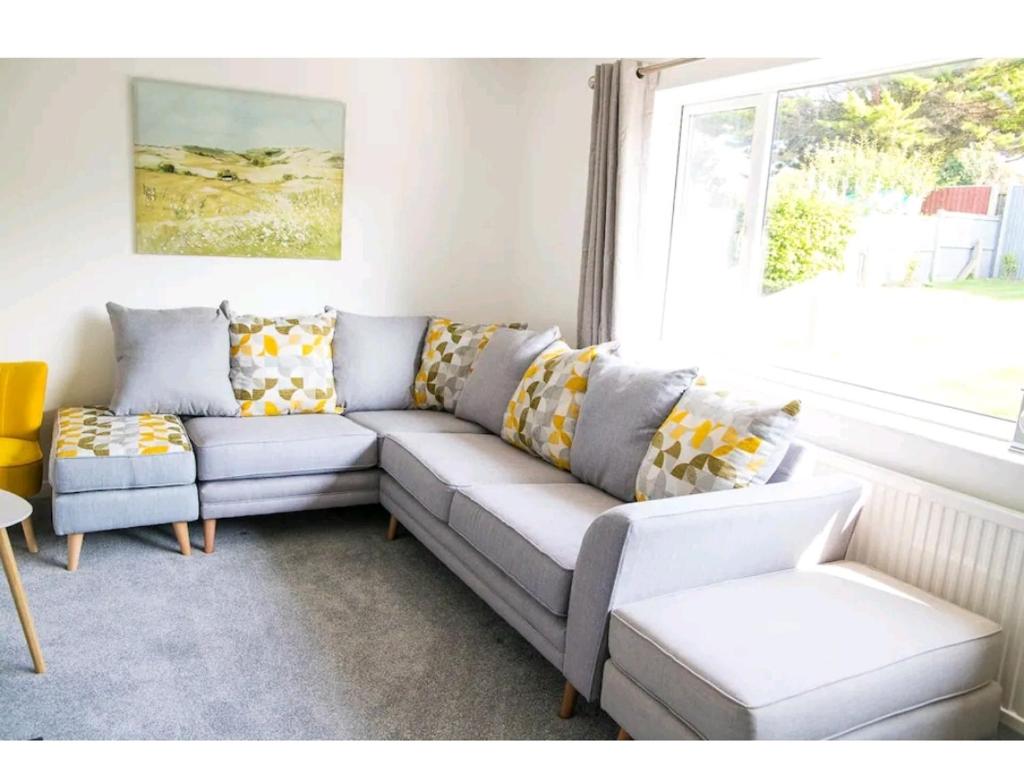 a living room with a couch and a window at The Retreat, Cromer in Cromer