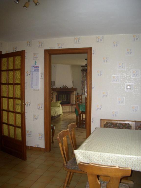 a dining room with a table and chairs and a room at le gutty - maison de vacances in Natzwiller